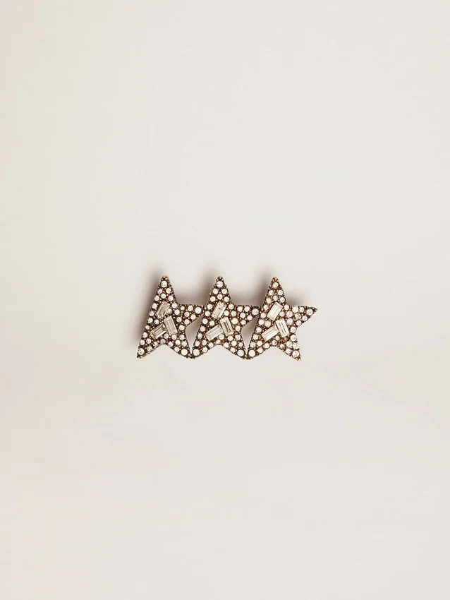 Accessoire en dentelle orné de trois étoiles couleur or antique et de cristaux
