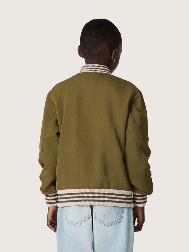 Blouson aviateur unisexe Journey en sergé de nylon vert militaire avec écusson brodé