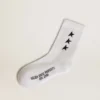 Chaussettes blanches ornées d’étoiles noires contrastantes