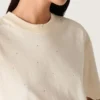 Chemise unisexe « Star » en coton blanc, ornée de cristaux dégradés sur toute la surface et d’un imprimé dans le dos