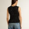 Haut en maille noire avec paillettes et détails contrastés