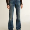 Jean bootcut pour femme au délavage vintage et aux détails métalliques