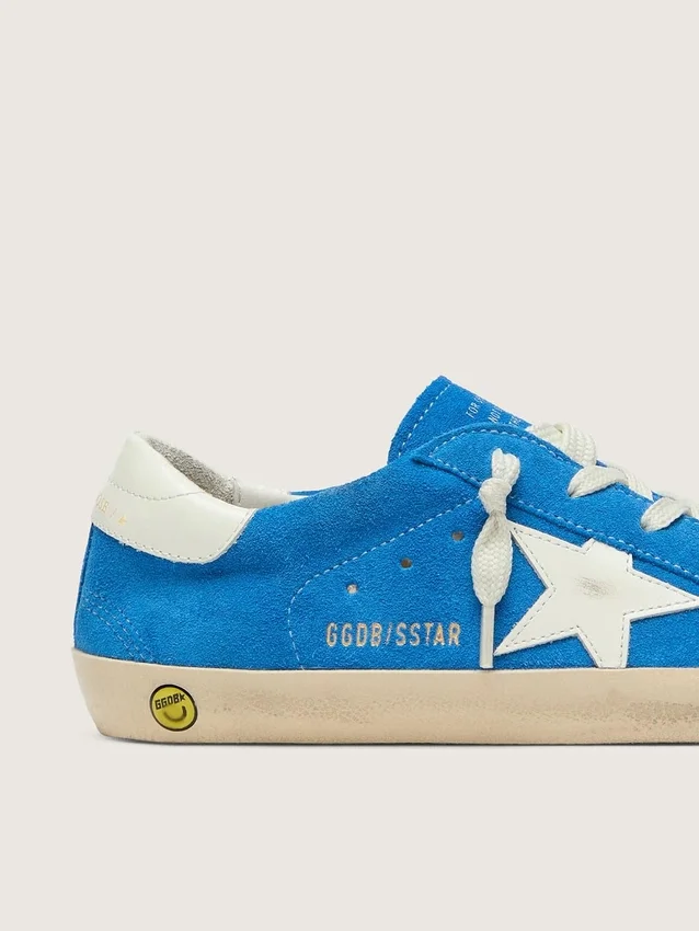 Jeune Super-Star en daim bleu vif avec une étoile en cuir blanc
