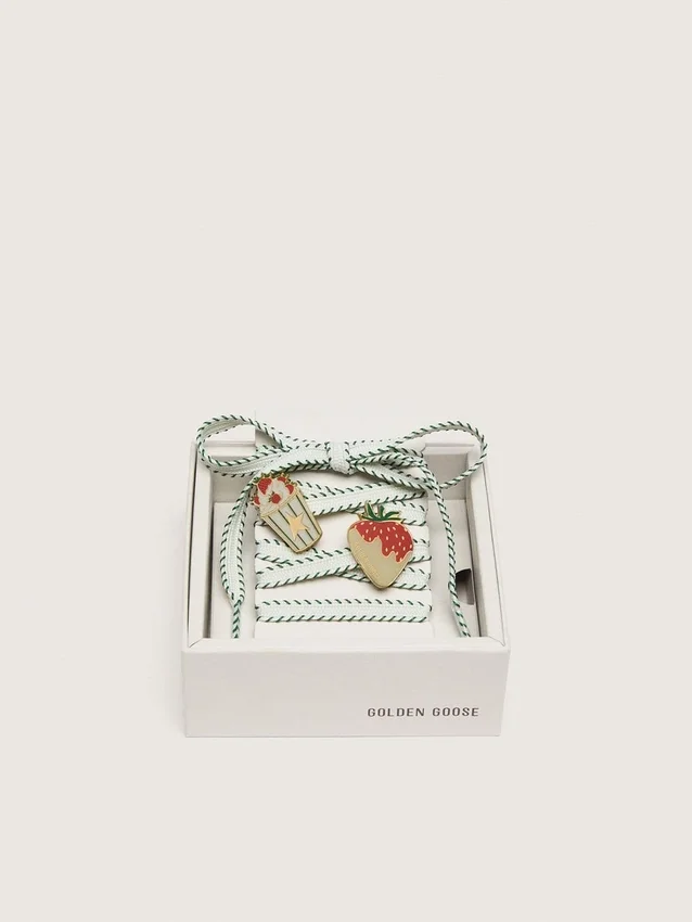 Lacets blancs « Peaux » avec broderie vert forêt et épingles en forme de fraise