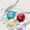 Lacets de peaux argentés avec quatre breloques colorées