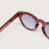 Lunettes de soleil Cameron Panthos avec monture couleur miel, pierres précieuses et verres bleus
