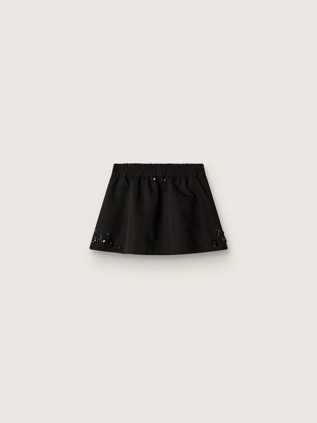 Mini-jupe pour femme en sergé de coton noir avec broderie florale en paillettes