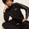 Sweat-shirt noir à fermeture éclair pour femme avec des étoiles blanches