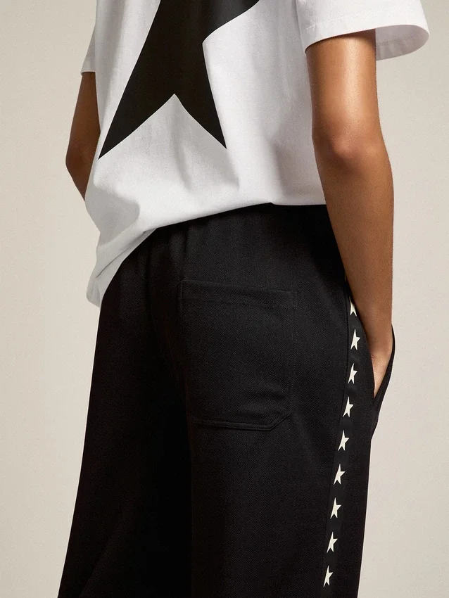 Pantalon de jogging noir pour femme avec des étoiles blanches sur les côtés