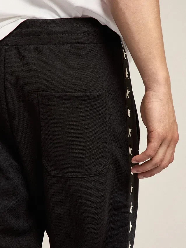 Pantalon de jogging noir pour homme avec des étoiles blanches sur les côtés