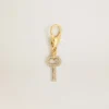 Pendentif en forme de clé en laiton doré orné de cristaux