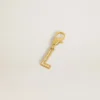 Pendentif lettre L en laiton doré orné de cristaux