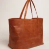 Sac Pasadena en cuir martelé brillant couleur beige clair avec logo doré sur le devant