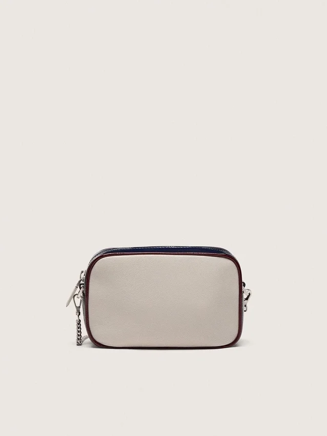 Star Bag en cuir blanc beurre avec étoile noire et détails bordeaux et bleu foncé