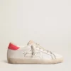 Super-Star en cuir blanc pour femme, avec étoile perforée et languette de talon en nylon fuchsia