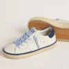 Super-Star Junior en cuir blanc avec languette de talon en daim bleu