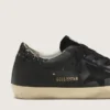 Super-Star pour femme en nappa noir avec étoile noire et languette de talon pailletée