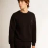 Sweat-shirt noir de la Star Collection avec une étoile ton sur ton sur le devant