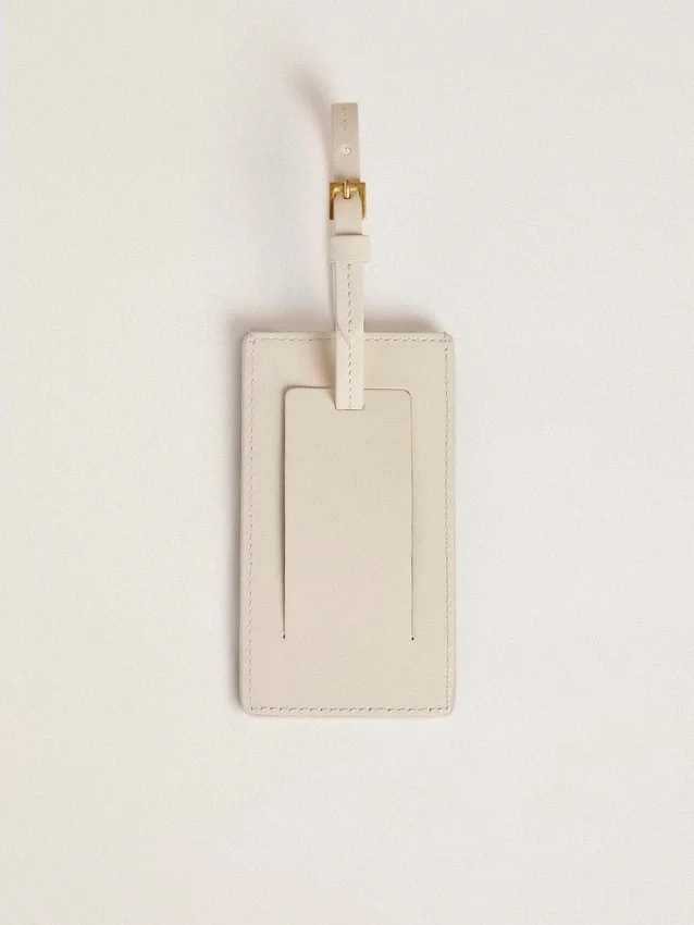 Étiquette de bagage blanche usée